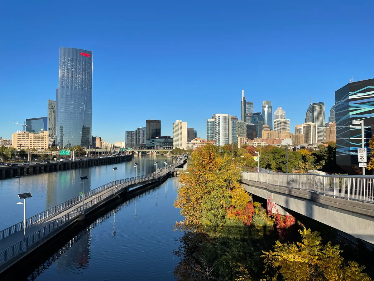 The Schuylkill River Trail beside the river, with bridges and the Philadelphia skyline beyond